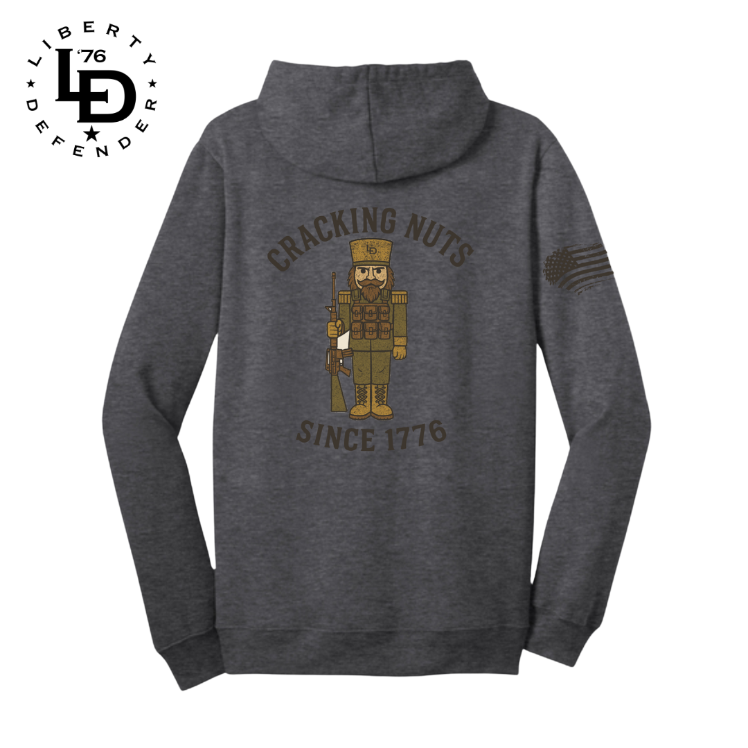 Gray hoodie with nutcracker design and text on the back, on a white background.