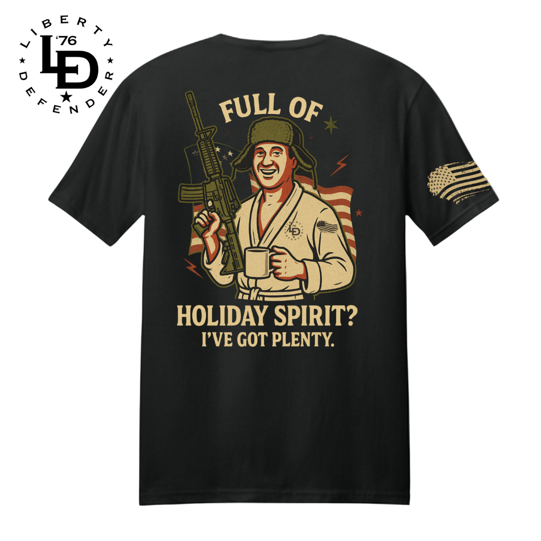 Black Full of Holiday Spirit shirt with humorous winter character holding a mug and rifle, plus Liberty Defender sleeve flag