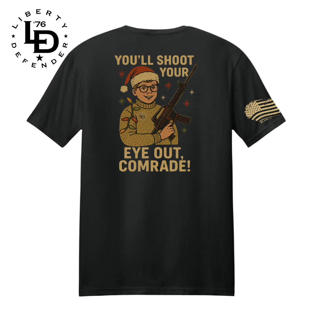 Black Holiday Hazard tee with vintage Christmas-style character in sweater and Santa hat holding a rifle, plus Liberty Defender sleeve flag.