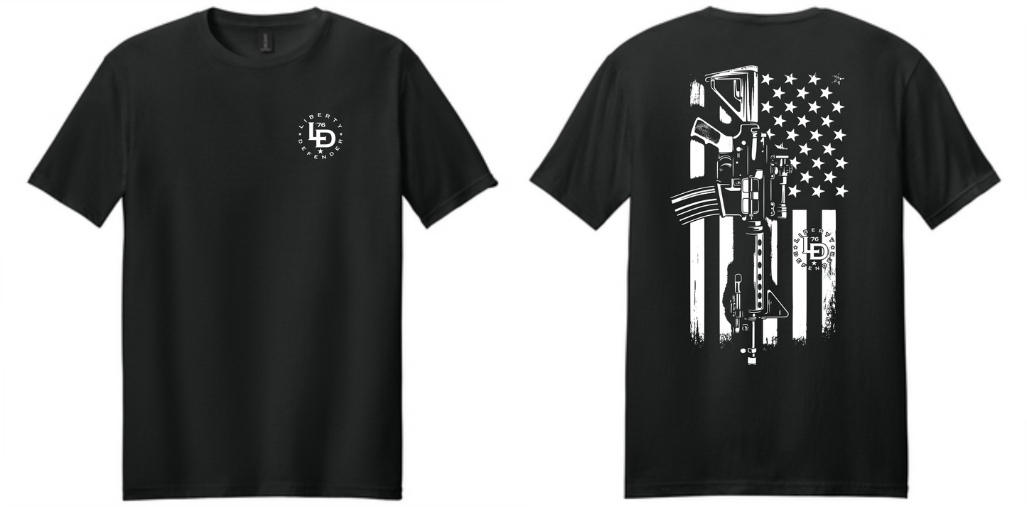 Patriotic black t-shirt featuring a vertical rifle silhouette layered over a weathered American flag graphic